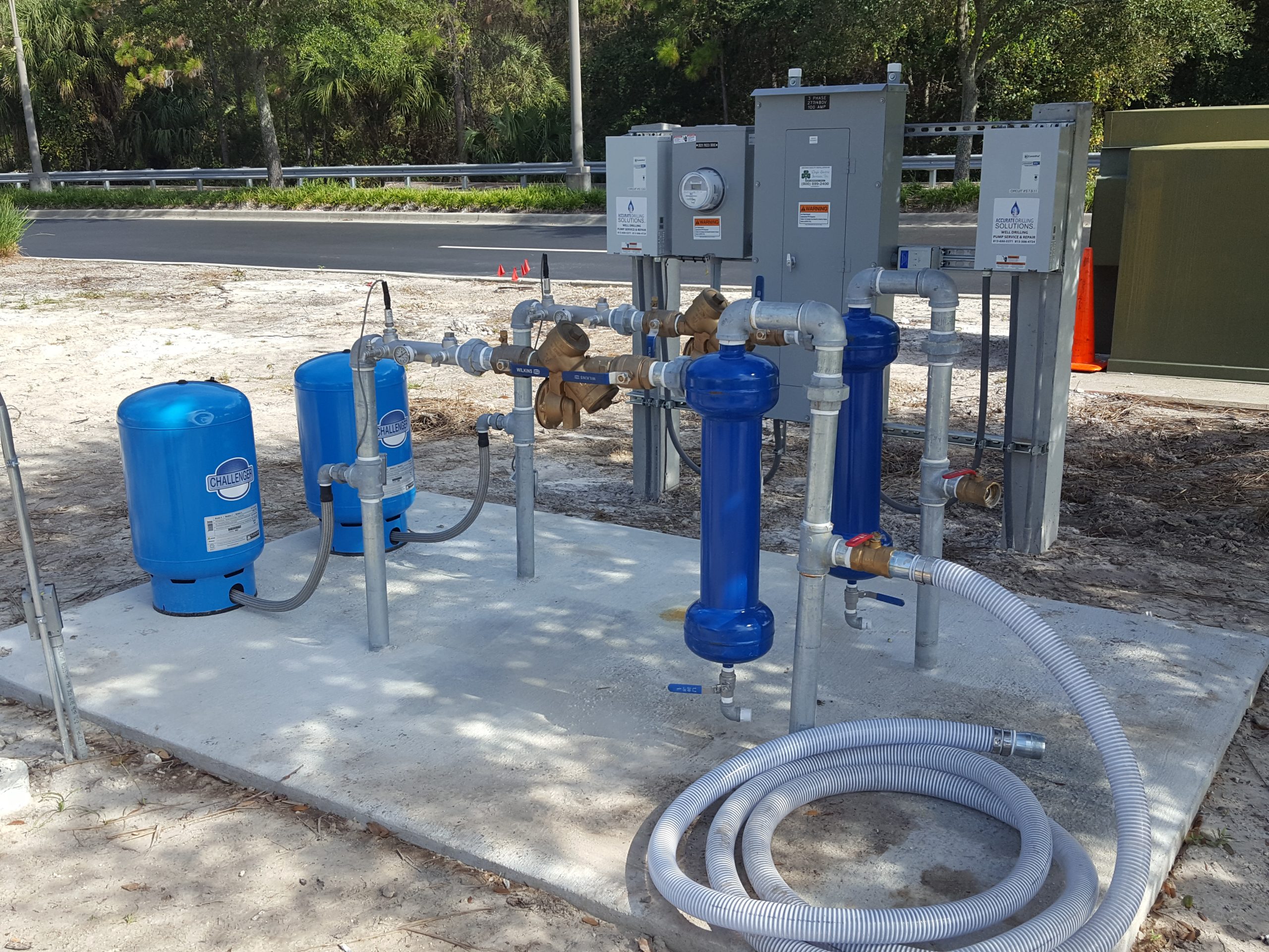 Homeowner reviewing a video well inspection checklist beside a residential wellhead in Parrish